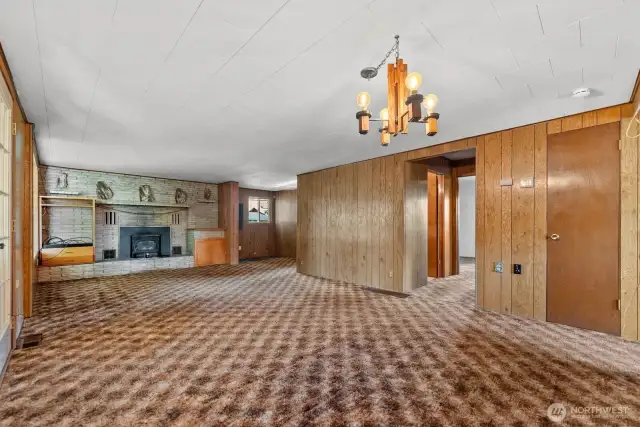 Living room and dining room share big picture windows looking out at Treed yard beauty.