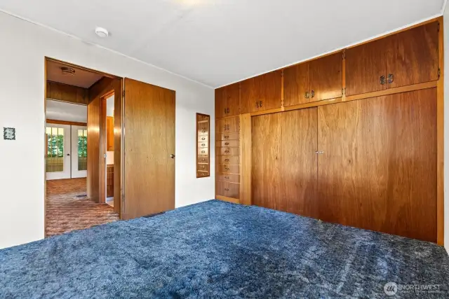 Primary Bedroom Built in dressers and closet.