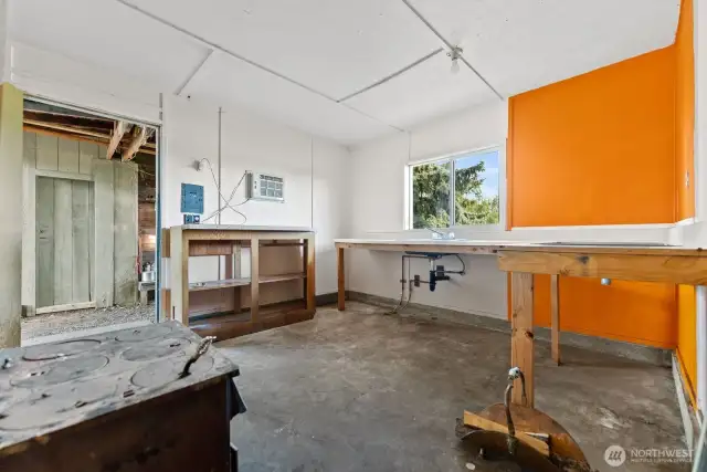 Additonal outbuilding studio with electric and wood stove.