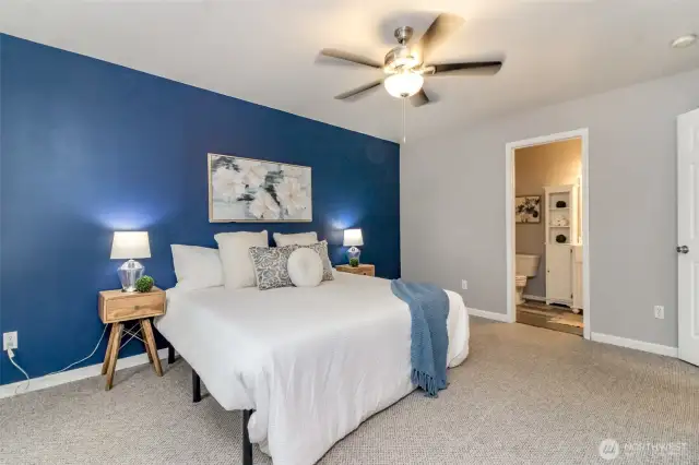 Primary bedroom on main floor, ceiling fan and fully remodeled ensuite and a walk in closet.