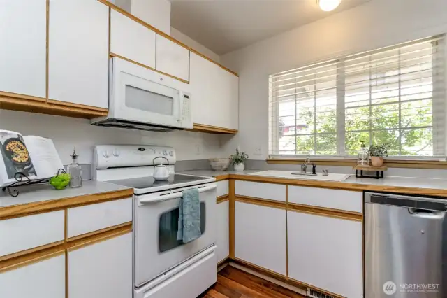 Light and bright kitchen faces the front of the house overlooking the covered front porch.