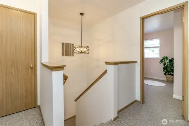 Top of stairs landing with linen closet.