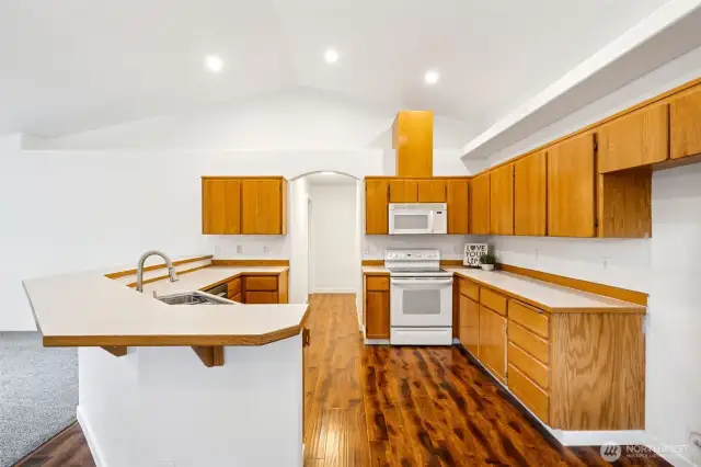 The open Kitchen features vaulted ceilings, multiple prep areas, and multiple ways to access in and out of the Kitchen.