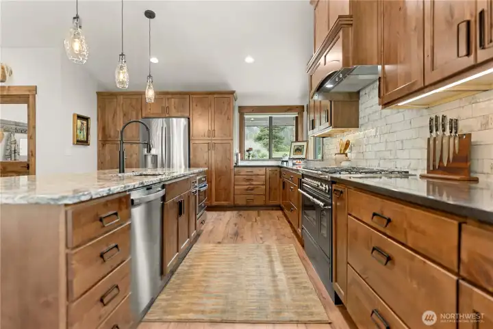 Expansive counter space is paired with deep drawers and upper cabinetry, providing organized storage while keeping the look clean and sophisticated.