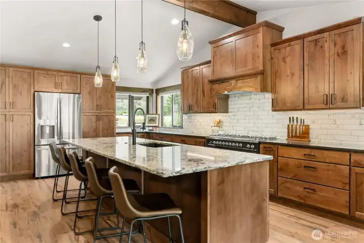 From this view, the open flow into the dining and living areas is clear, emphasizing how the kitchen serves as the heart of the home for cooking, entertaining, and gathering.