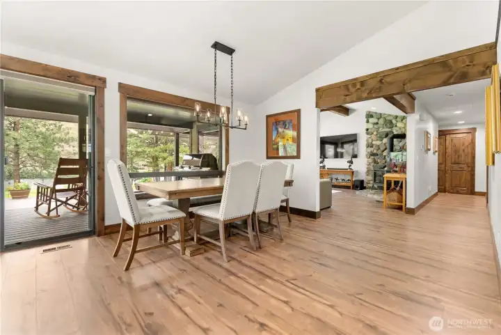 Enjoy seamless indoor-outdoor living with direct access to the covered patio from the dining area. The warm wood floors flow into the living room, where a stunning stone fireplace becomes the centerpiece of the home.