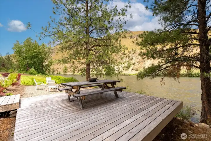 Nestled beneath mature pines along the riverbank, this private deck creates the perfect retreat. Enjoy outdoor meals, morning coffee, or evening gatherings while soaking in the peaceful sights and sounds of the flowing water.