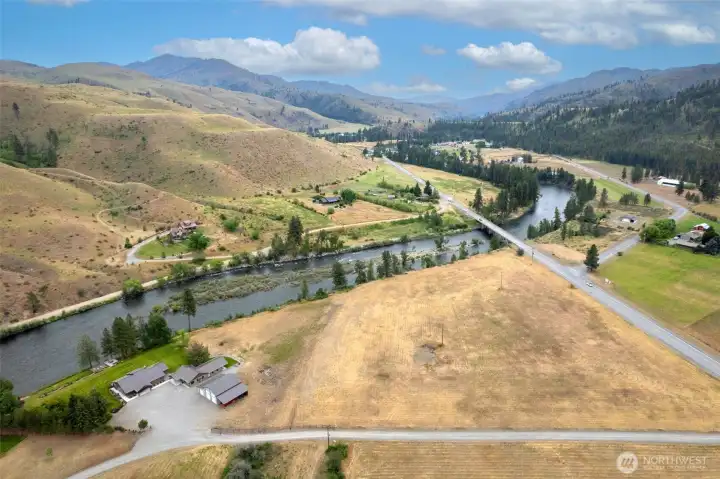 This rare 10.5-acre riverfront property offers both privacy and space in a breathtaking setting. With sweeping views of the river and surrounding hills, the land provides endless possibilities—whether for recreation, expansion, or simply enjoying the natural beauty. The combination of wide-open fields, mature landscaping around the home, and direct river frontage makes this property a unique retreat with room to roam.