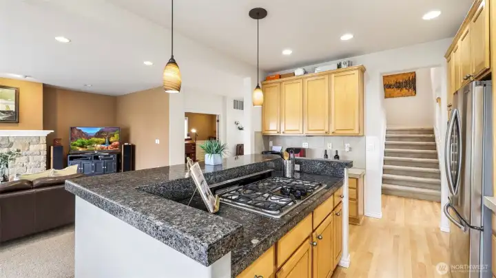 Open kitchen with elegant granite finishes and seamless flow to the living area