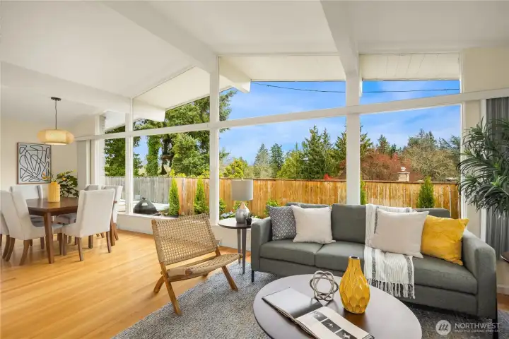 Exposed beams soar overhead, anchored by warm hardwood floors below.