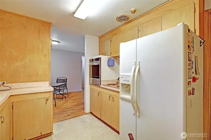 Kitchen with side by side refrigerator./freezer combo..to the right stairs to the lower level.