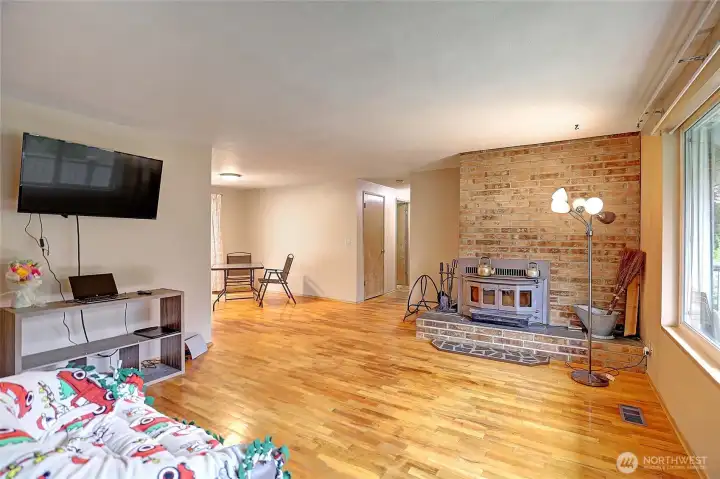 Gather around the brick wall with fireplace wood insert.  Makes the home cozy.  Natural gas added plus!