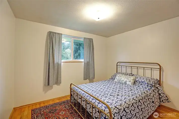 Bedroom #2 on main level with wood floor.