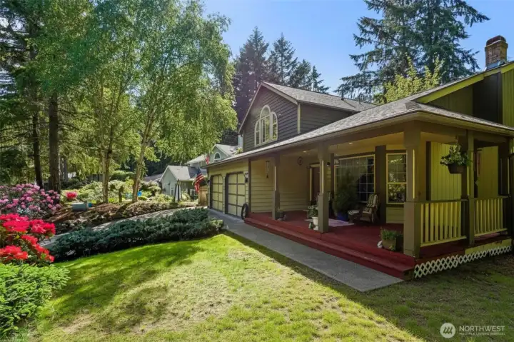 Expansive covered front porch perfect for relaxing and enjoying the peaceful surroundings.