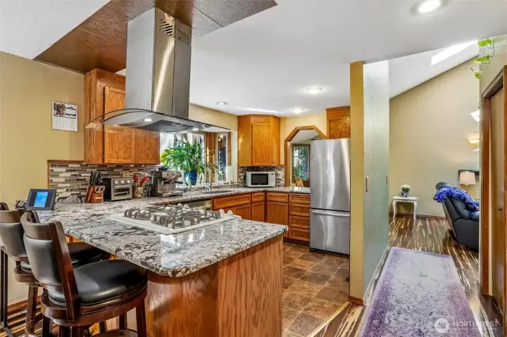 The kitchen island, pass-through window, and dining space all work together so naturally for everyday living and hosting.