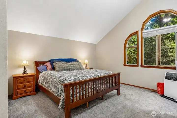 The primary bedroom windows make it feel like you’re waking up in the trees every morning.