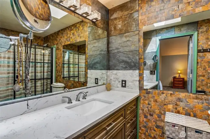 Not your builder-basic bathroom. The textures and finishes in here give it such a unique vibe.