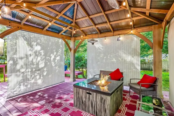 This covered outdoor space is what Pacific Northwest living is all about. String lights, a fire feature, and year-round enjoyment no matter the season.