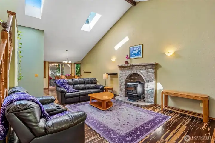 Spacious living room featuring soaring vaulted ceilings and abundant natural light