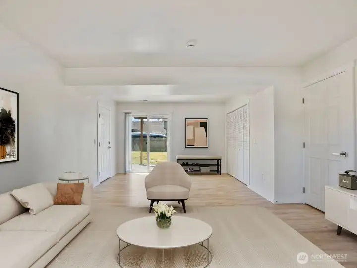 Virtually staged family room facing laundry and backyard