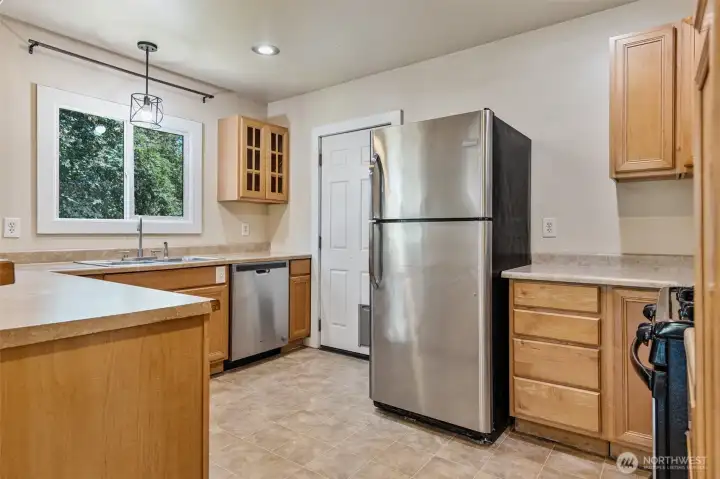 Fridge and dishwasher - the door in the rear of the photo is the back door at the staircase in the second photo