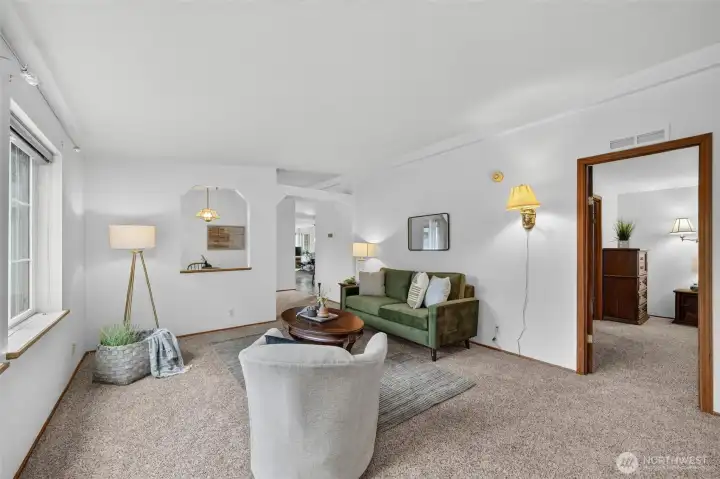 The view of the living room as you enter the home. The doorway to the right leads to the primary bedroom suite. The view of the living room as you enter the home. The doorway to the right leads to the primary bedroom suite.