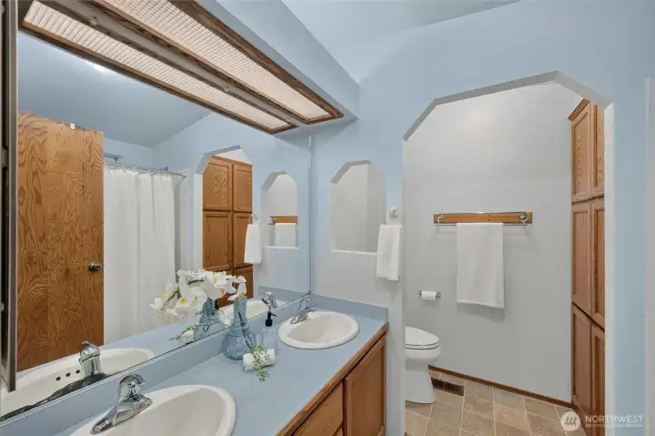 Primary ensuite bathroom with 2 sinks and a Bathfitters walk-in shower. Primary ensuite bathroom with 2 sinks and a Bathfitters walk-in shower.