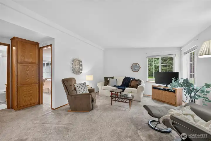 This home has a heat pump with AC to keep you cool in the summer! Another view of the family room. To the left are 2 bedrooms and a full bathroom. This home has a heat pump with AC to keep you cool in the summer! Another view of the family room. To the left are 2 bedrooms and a full bathroom.