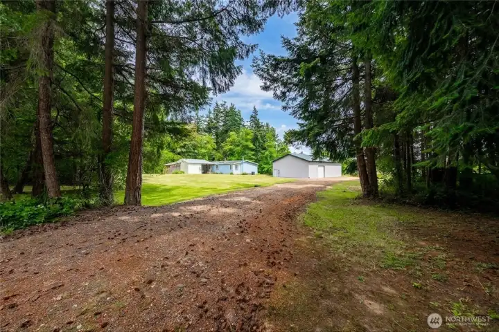 This property features 2 driveways. This is the 2nd driveway on the north side of the property, which leads to the back side (3rd roll-up door) of the shop. This property features 2 driveways. This is the 2nd driveway on the north side of the property, which leads to the back side (3rd roll-up door) of the shop.