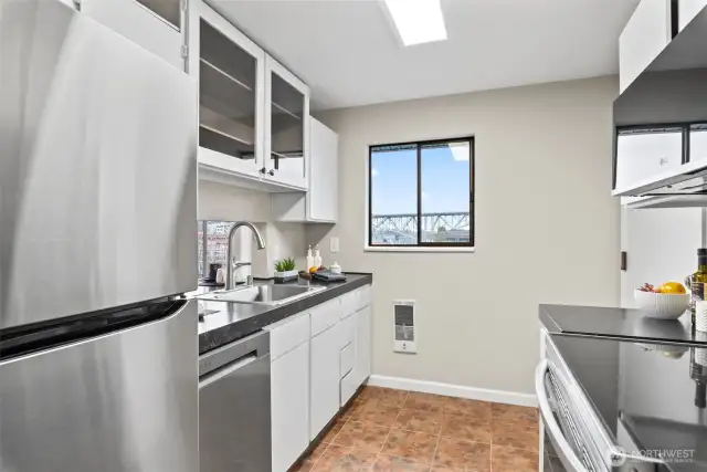 Another view of the kitchen with new fridge and dishwasher.