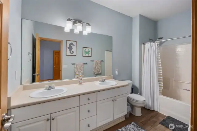 The primary bathroom features dual sinks for added convenience, along with a spacious layout