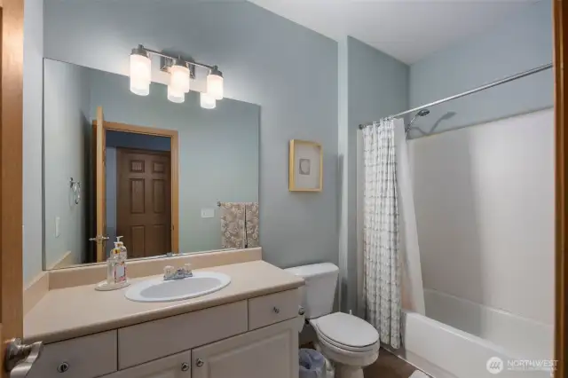 A second full bathroom conveniently serves the additional two bedrooms, offering a clean, functional space with plenty of room for daily use.