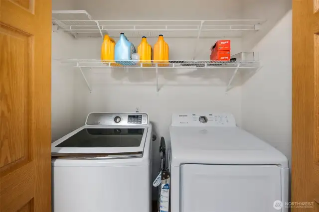Convenient in-kitchen laundry with a dedicated washer and dryer tucked behind doors—efficiently designed for easy access while maintaining a tidy look.