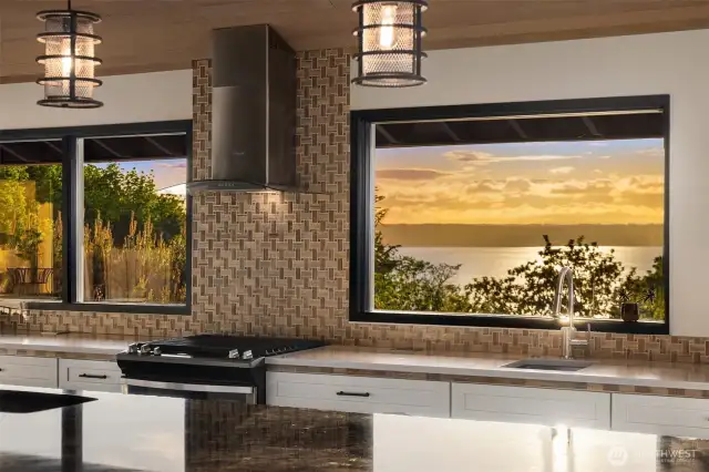 The kitchen windows flow into the view and layered outside living spaces.