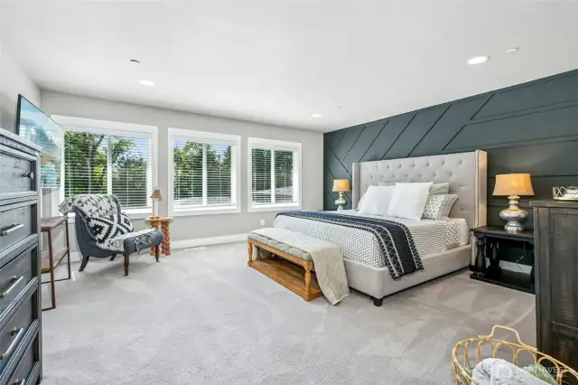 Light-filled primary suite provides a true retreat with dual walk-in closets and a luxurious five-piece bath designed with spa-like tranquility.