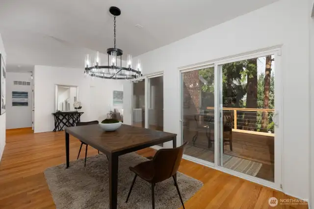 DINING AREA WITH LARGE SLIDING DOOR ACCESSING THE SPACIOUS DECK