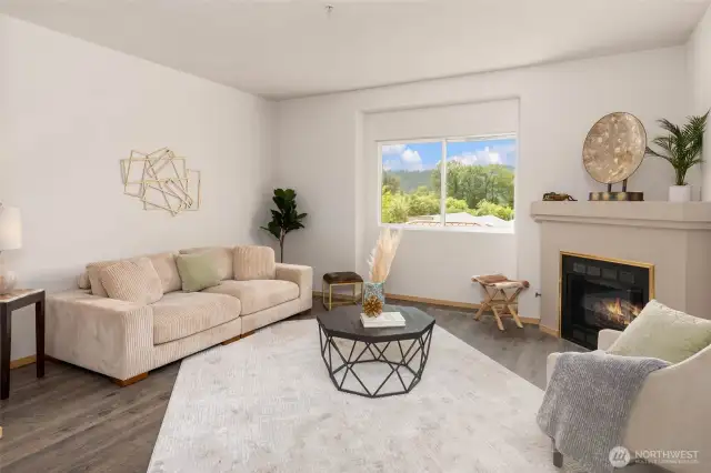 Bright living room with serene views of the valley and a cozy corner fireplace