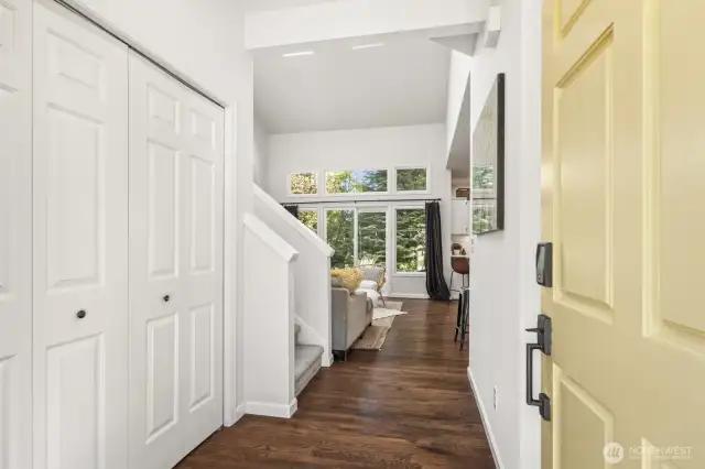 The foyer provides an airy and inviting feeling from the large windows and vaulted ceiling.
