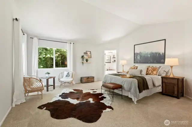 At the top of the stairs is the entrance to the primary bedroom, with vaulted ceilings and oodles of space to create your own indoor oasis.