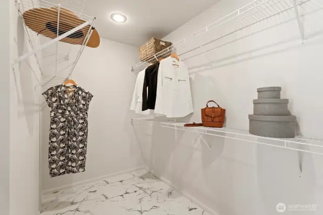 The new tile flooring continue into the walk-in closet, which has abundance space for all your apparel.