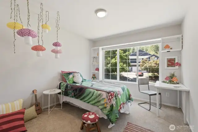 The second bedroom is perfectly sized and includes a large mountain view window and closet system.