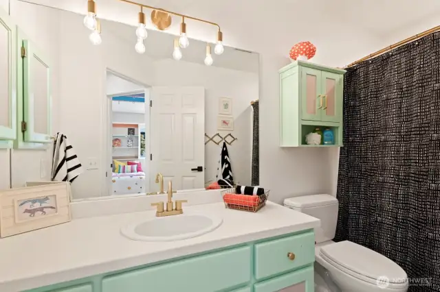 The second full bathroom has updated fixtures and lots of storage cabinets and counter space.