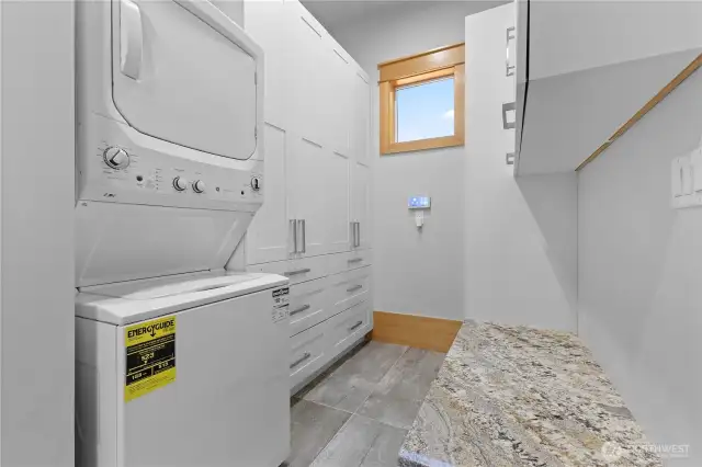 Main floor laundry/mud room with tons of cabinets