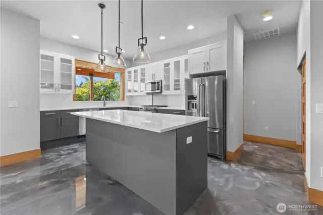 Lower kitchen with breakfast bar and all appliances, epoxy flooring