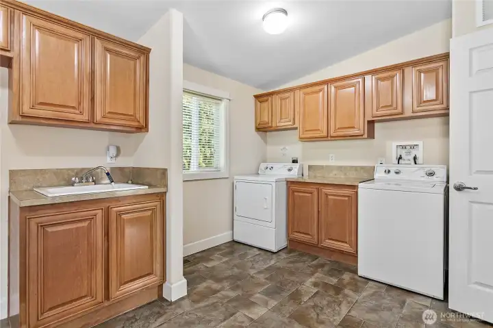 Huge utility/multi-purpose room w/tons of built in cabinets