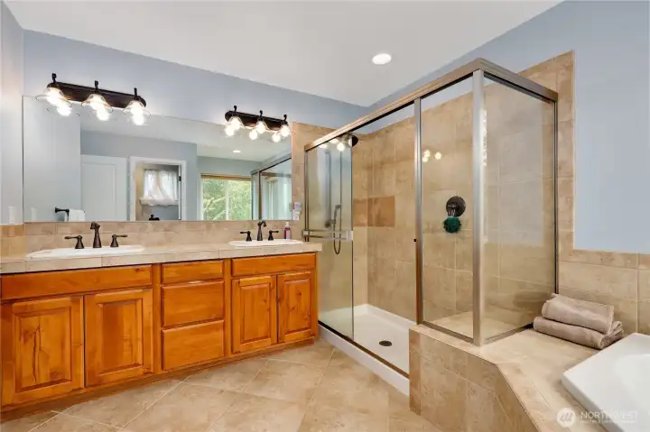 Nothing fancy, just a clean, spa-inspired retreat with a soaking tub and walk-in tile shower for your daily reset.
