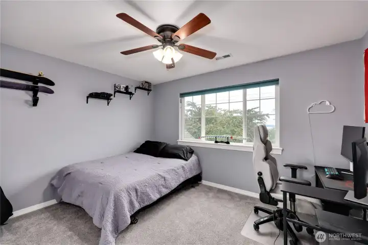 A bright, uncomplicated second bedroom that makes the most of the natural light and neutral tones.