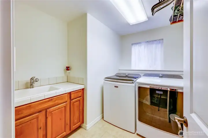 The utility hub. Built-in cabinets and shelving keep the laundry cycle organized and out of the way.