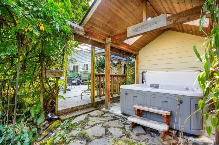 Covered hot tub area w/ skylights to keep area cheery & protected