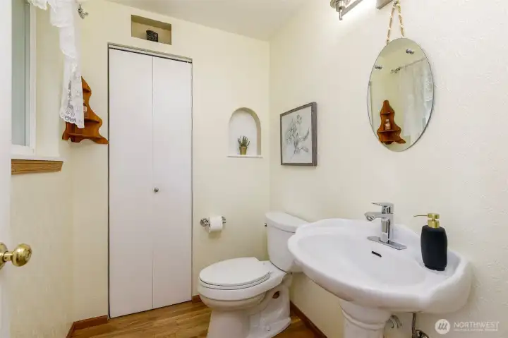 Spacious powder room w/ large pedestal sink & large closet area too